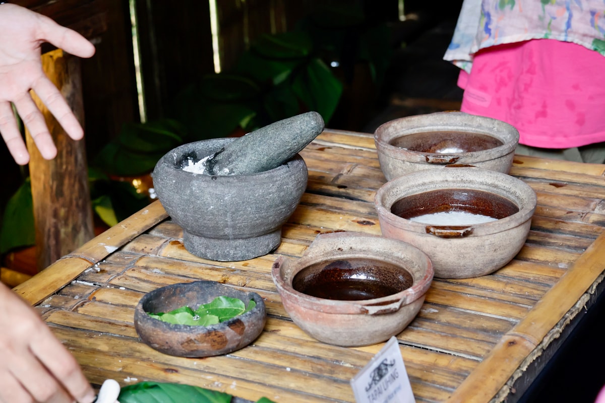 Ayurvedic herbs and clay bowls with mortar and pestle
