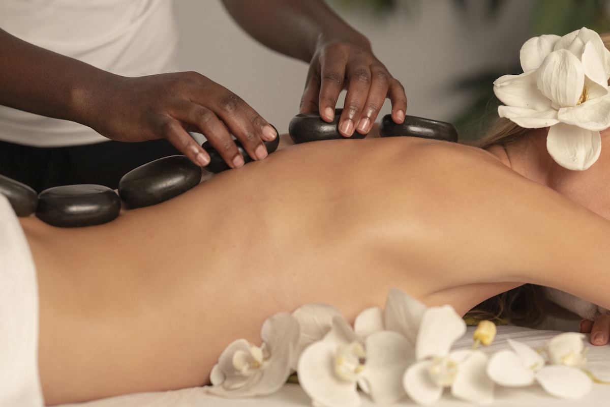 Ayurvedic hot-stone therapy with white flowers